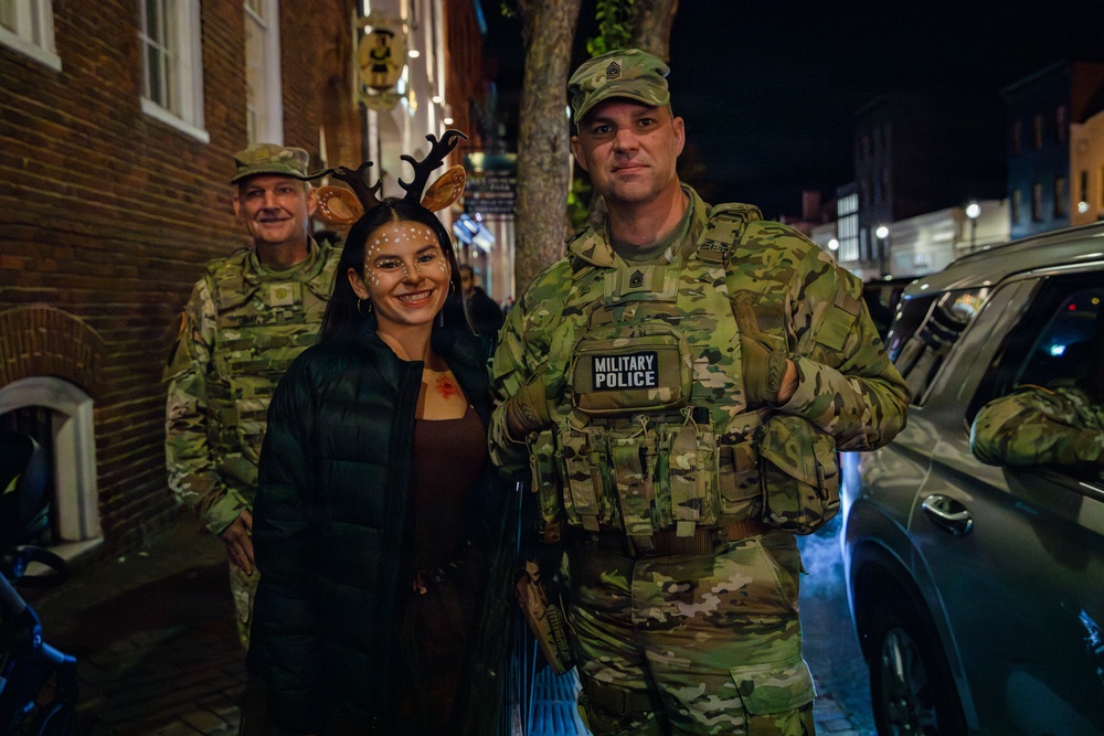 Joint Task Force Magnolia leadership takes pictures with the public on patrol on Halloween