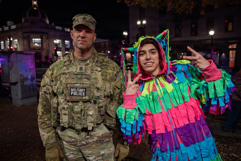 Joint Task Force Magnolia leadership takes pictures with the public on patrol on Halloween