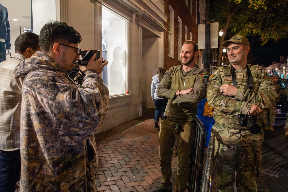 An Alabama National Guard Airman takes a photo with the public during Halloween