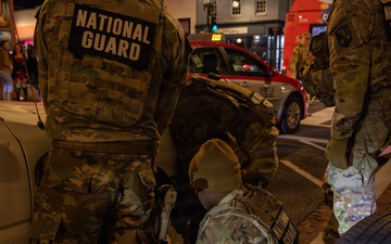 Joint Task Force Magnolia Soldiers change a tire on Halloween