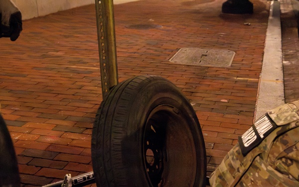 Joint Task Force Magnolia Soldiers change a tire on Halloween