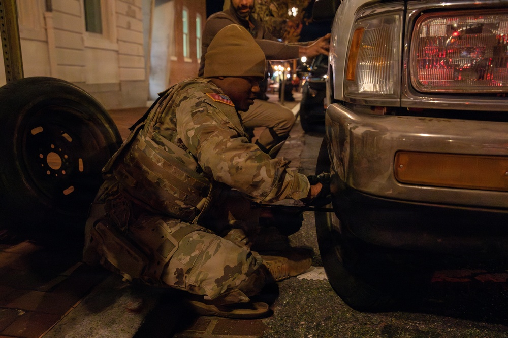 A Mississippi Army National Guard Soldier changes a tire on Halloween