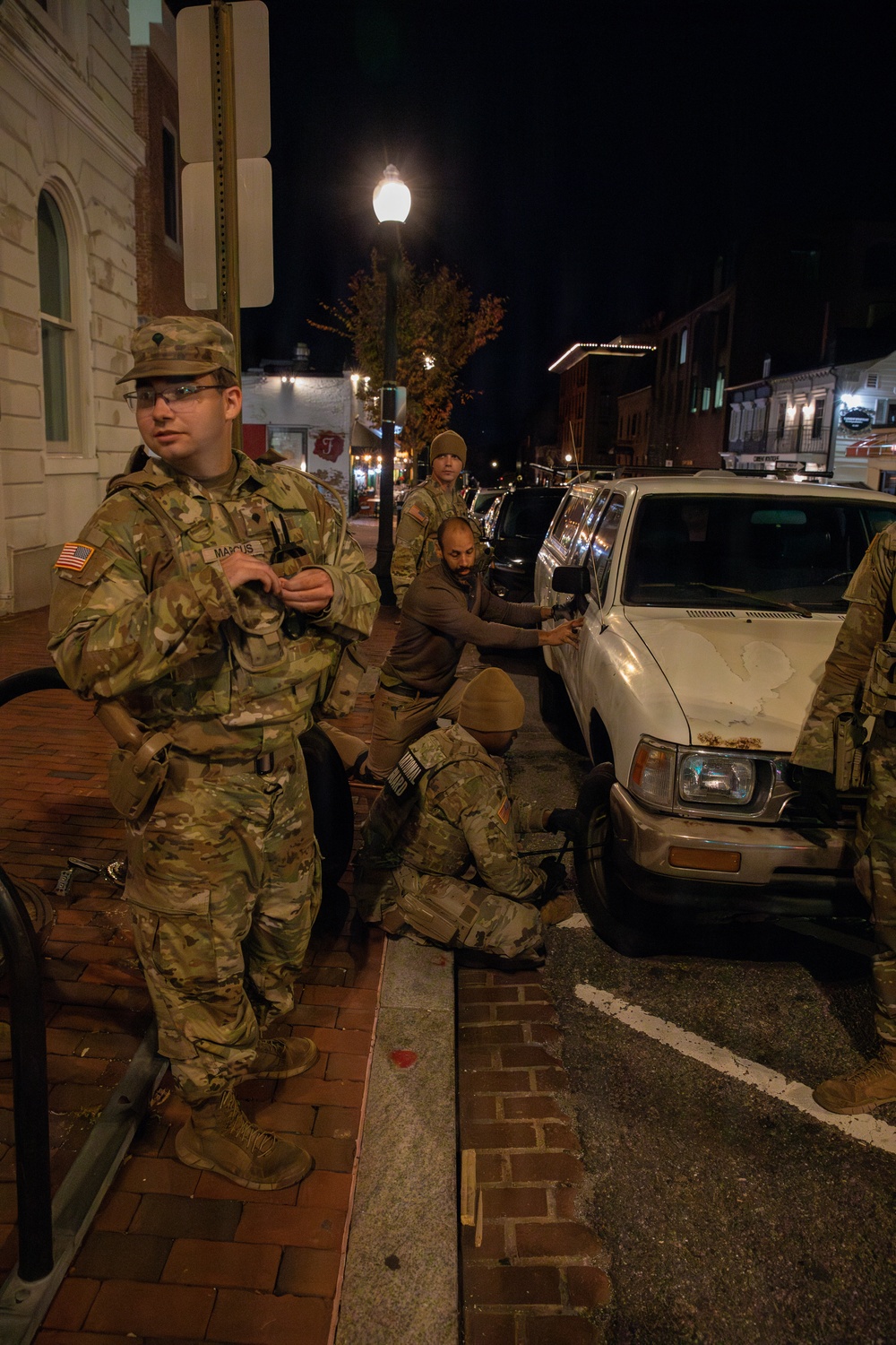 A Mississippi Army National Guard Soldier changes a tire on Halloween