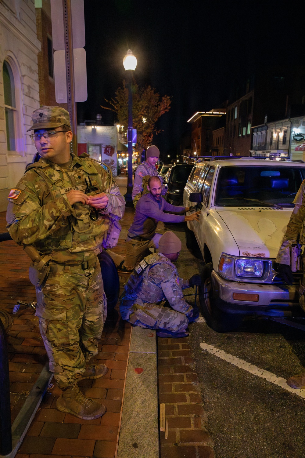 A Mississippi Army National Guard Soldier changes a tire on Halloween