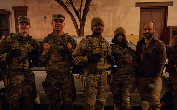 Mississippi Army National Guard Soldiers help change a tire on Halloween