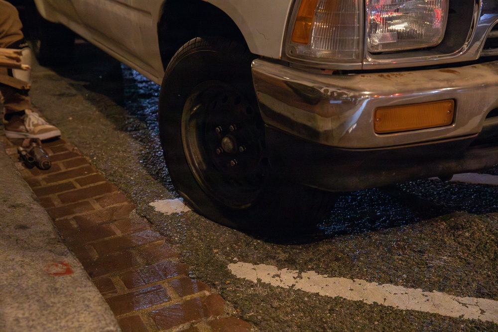 Mississippi Army National Guard Soldiers help change a tire on Halloween