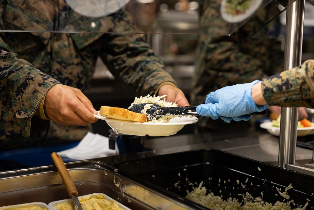 U.S. Marines and Sailors, celebrate a Thanksgiving meal while on European deployment