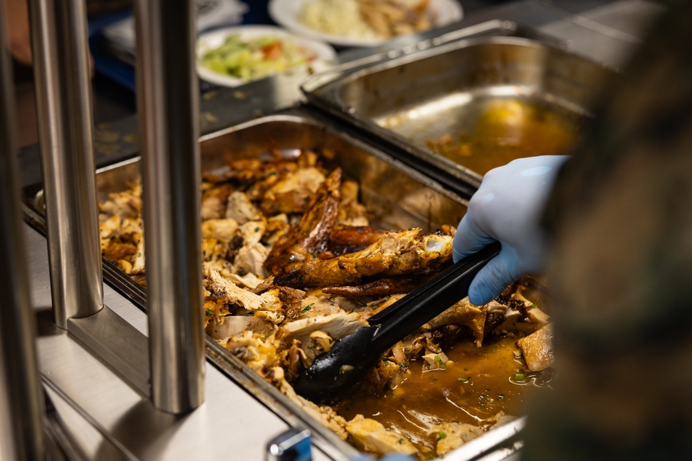 U.S. Marines and Sailors, celebrate a Thanksgiving meal while on European deployment
