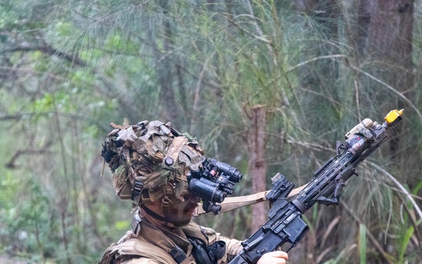 Soldier inspects rifle