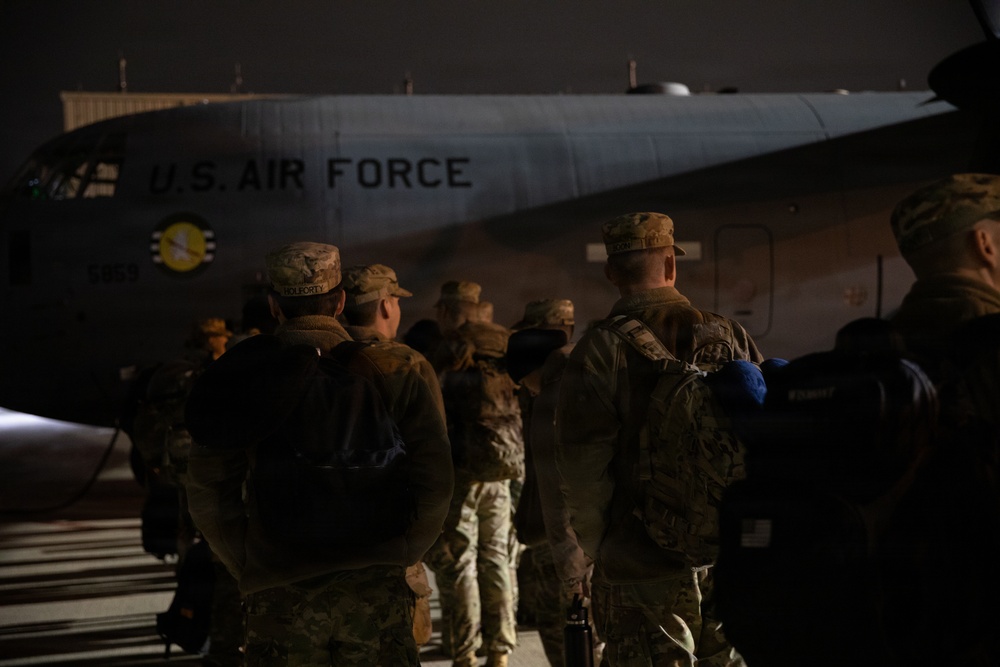 147th Army Band, South Dakota Army National Guard soldiers line up in front of a Kentucky Air National Guard C-130J Super Hercules