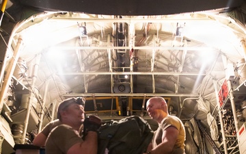 147th Army Band, South Dakota Army National Guard soldiers unload their equipment from a Kentucky Air National Guard C-130J Super Hercules