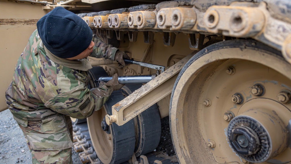 U.S. Army Soldier performs maintenance on an M1 Abrams