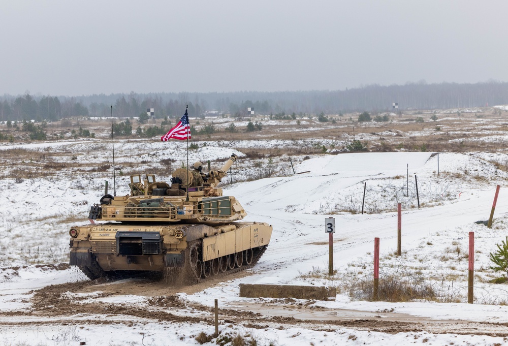 U.S. Soldiers prepare to fire an M1 Abrams tank during the Iron Spear Tank Competition