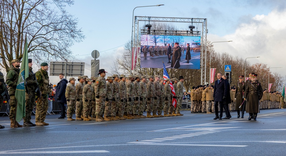 U.S. Army Soldiers render a salute to Latvia’s president