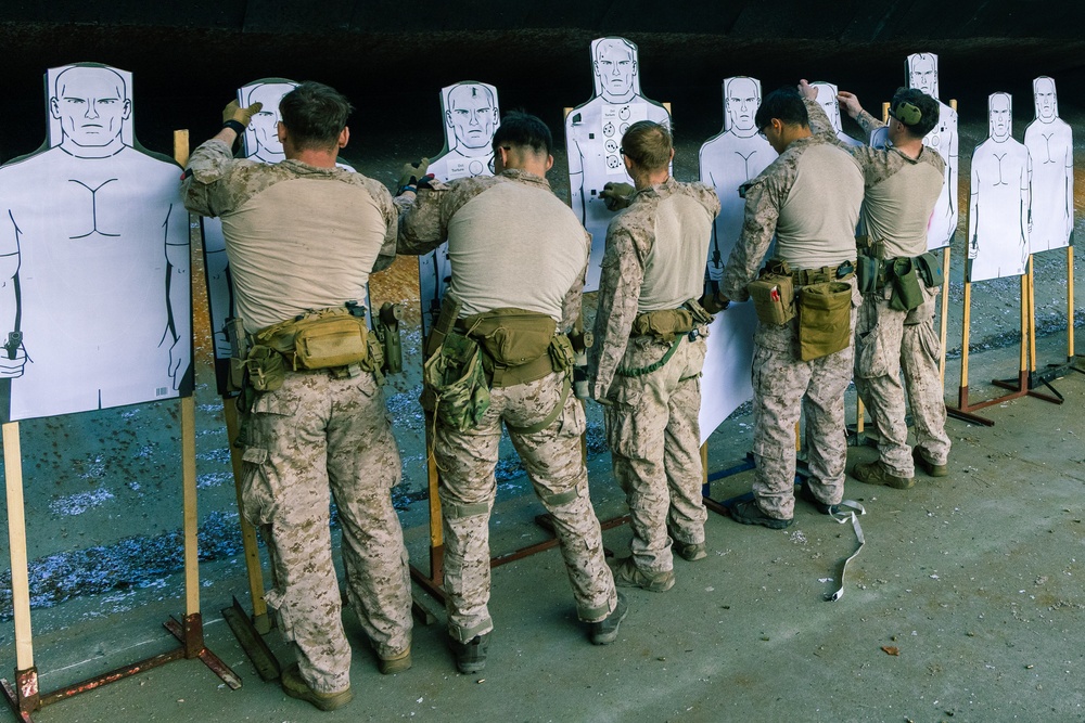 Reconnaissance Marines with the 24th Marine Expeditionary Unit mark targets after pistol shooting drills