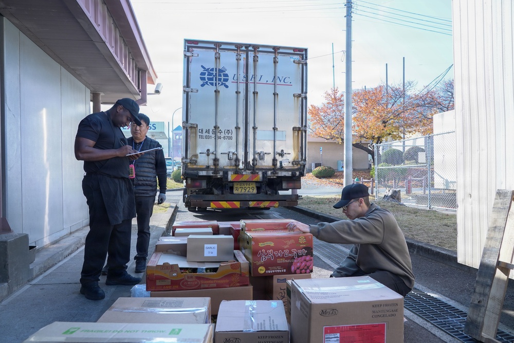 Workers unload fresh food at the Market 19 dining facility