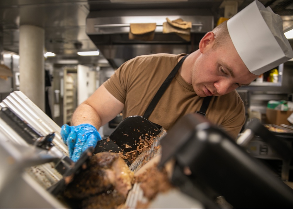 USS Mitscher (DDG 57) Sailor prepares Thanksgiving food