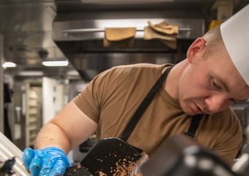 USS Mitscher (DDG 57) Sailor prepares Thanksgiving food