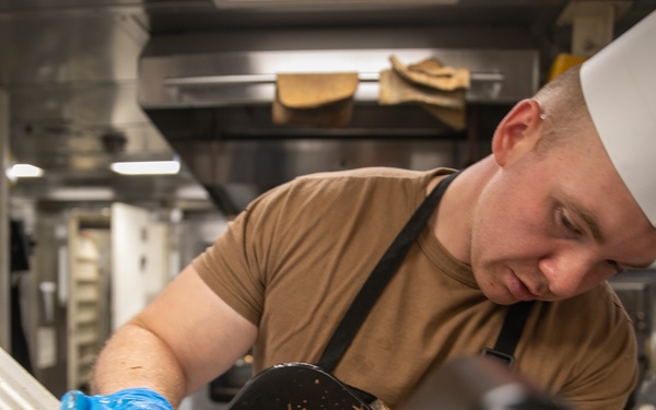 USS Mitscher (DDG 57) Sailor prepares Thanksgiving food