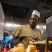 USS Mitscher (DDG 57) Sailor serves Thanksgiving meal
