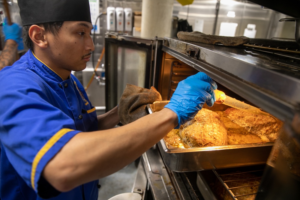 USS Mitscher (DDG 57) Sailor prepares Thanksgiving meal