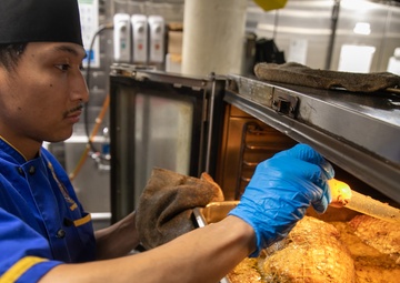 USS Mitscher (DDG 57) Sailor prepares Thanksgiving meal