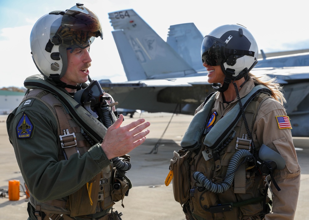 Lt. Ryan “Narp” Hubbs assigned to Strike Fighter Squadron (VFA) 106, briefs Lara Trump on flight line