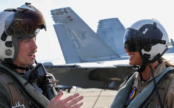 Lt. Ryan “Narp” Hubbs assigned to Strike Fighter Squadron (VFA) 106, briefs Lara Trump on flight line
