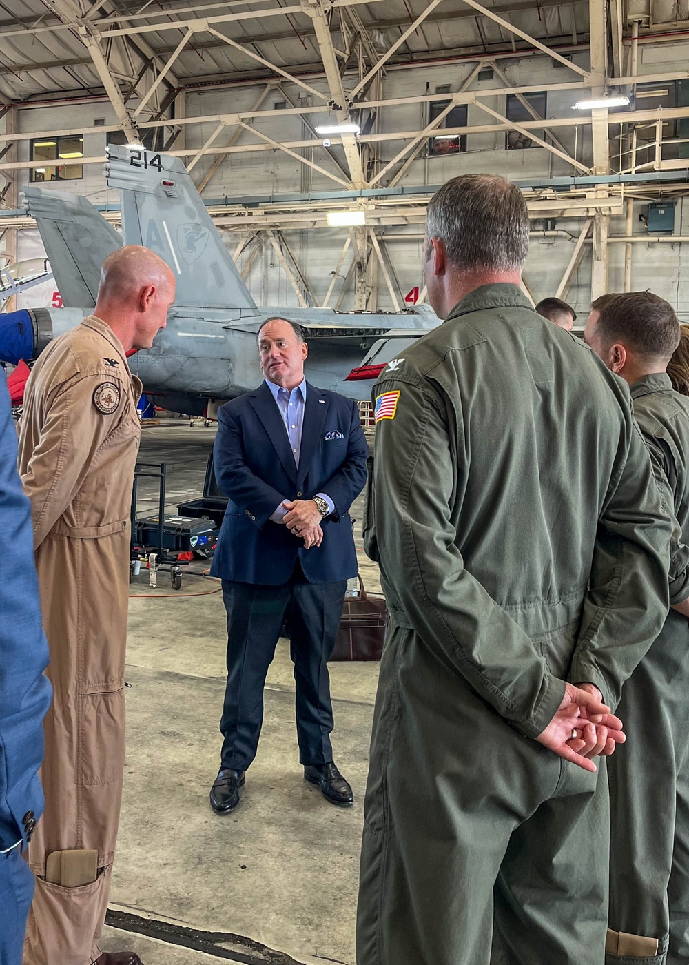 The Honorable John C. Phelan, Secretary of the Navy, speaks to the Capt. Eric McQueen, Commodore,