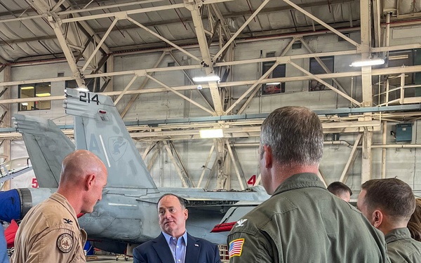 The Honorable John C. Phelan, Secretary of the Navy, speaks to the Capt. Eric McQueen, Commodore,