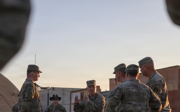 Brig. Gen. Kevin J. Lambert talks with soldiers before re-enlistment ceremony