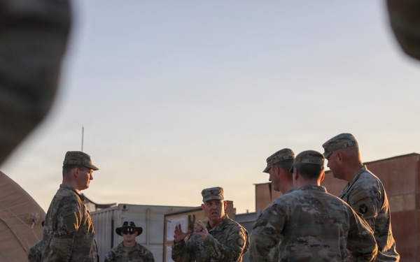 Brig. Gen. Kevin J. Lambert talks with soldiers before re-enlistment ceremony