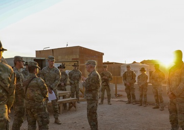 Brig. Gen. Kevin J. Lambert talks with soldiers before re-enlistment ceremony