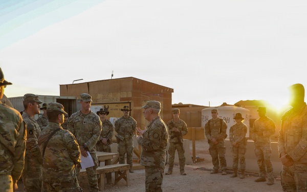 Brig. Gen. Kevin J. Lambert talks with soldiers before re-enlistment ceremony
