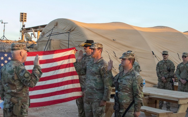 Brig. Gen. Kevin J. Lambert re-enlists two soldiers