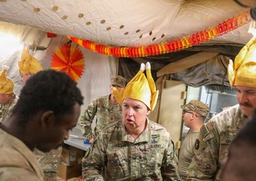 Brig. Gen. Kevin J. Lambert serves food to soldiers