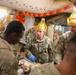 Brig. Gen. Kevin J. Lambert serves food to soldiers