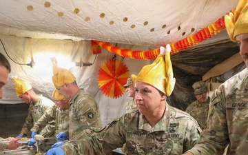 Brig. Gen. Kevin J. Lambert serves food to soldiers
