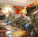 Brig. Gen. Kevin J. Lambert serves food to soldiers