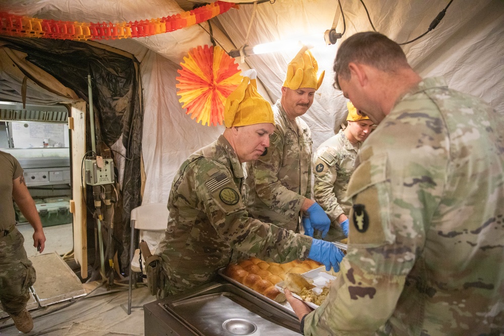 Brig. Gen. Kevin J. Lambert serves food to soldiers at Al-Tanf Garrison