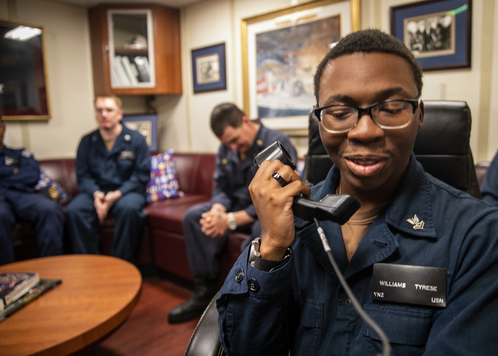 USS Mitscher (DDG 57) Sailor speaks on phone with U.S. Chief of Naval Operations