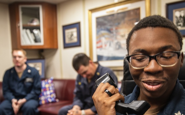 USS Mitscher (DDG 57) Sailor speaks on phone with U.S. Chief of Naval Operations