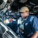 USS Mitscher (DDG 57) Sailor mans helm in ship bridge