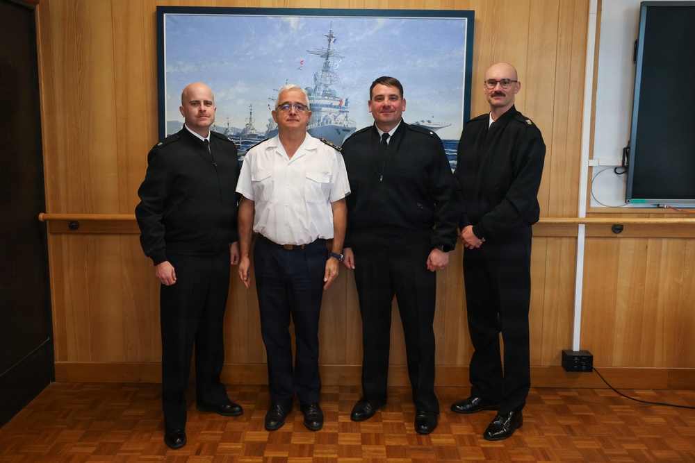 Cmdr. Joseph Phillips, commanding officer, USS Paul Ignatius (DDG 117) meets with French Navy Rear Adm. Vincent Gregoire and Capt. Pierre Suleau