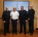 Cmdr. Joseph Phillips, commanding officer, USS Paul Ignatius (DDG 117) meets with French Navy Rear Adm. Vincent Gregoire and Capt. Pierre Suleau