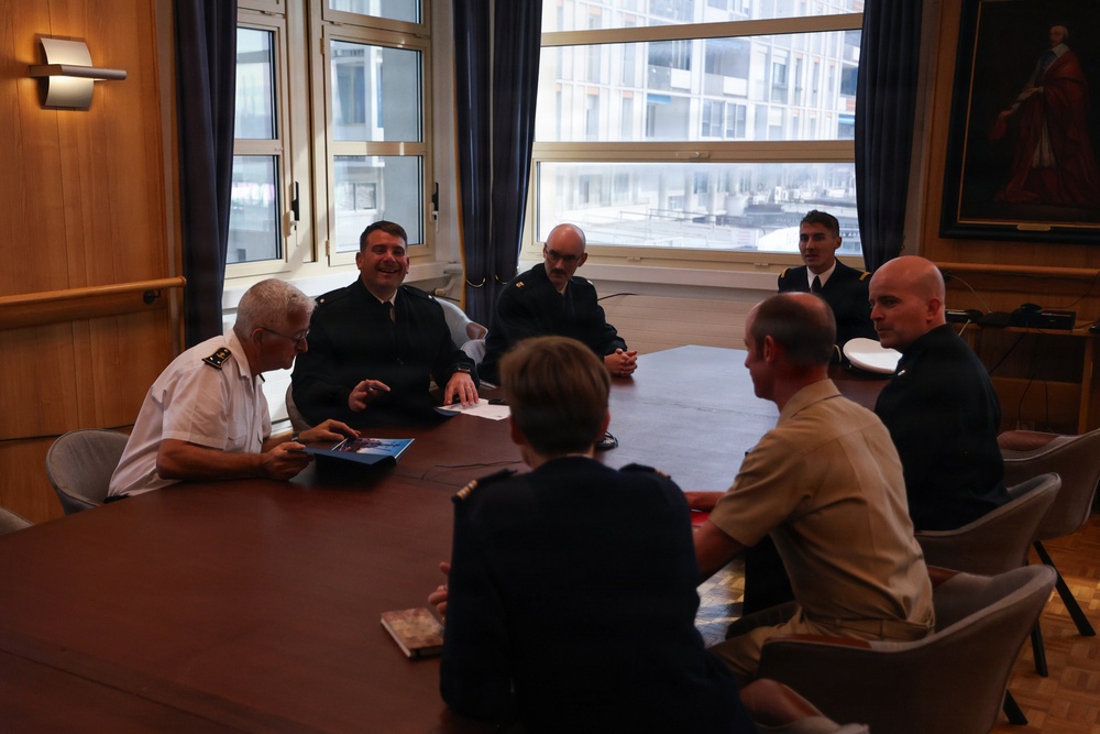 Cmdr. Joseph Phillips, commanding officer, USS Paul Ignatius (DDG 117) meets with French Navy Rear Adm. Vincent Gregoire and Capt. Pierre Suleau
