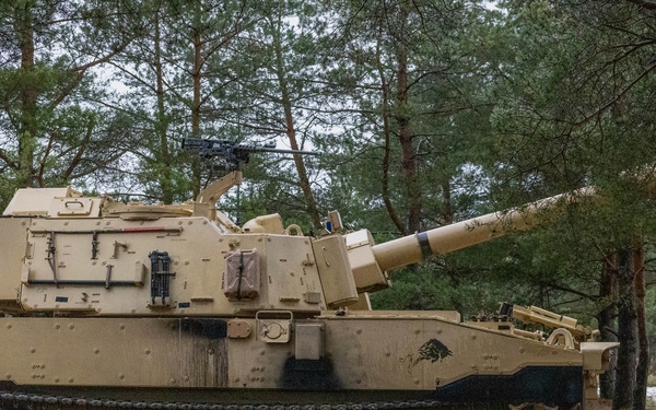U.S. Soldiers set up firing positions with a M109A7 Paladin Self-Propelled Howitzer