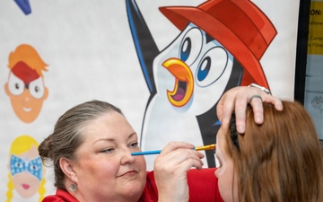 American Red Cross Volunteer Paints Child's Face