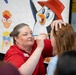 American Red Cross Volunteer Paints Child's Face