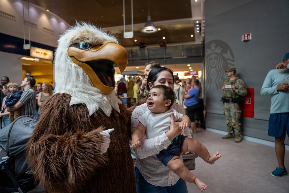 The AFN &quot;Eagle&quot; poses with AAFES patrons